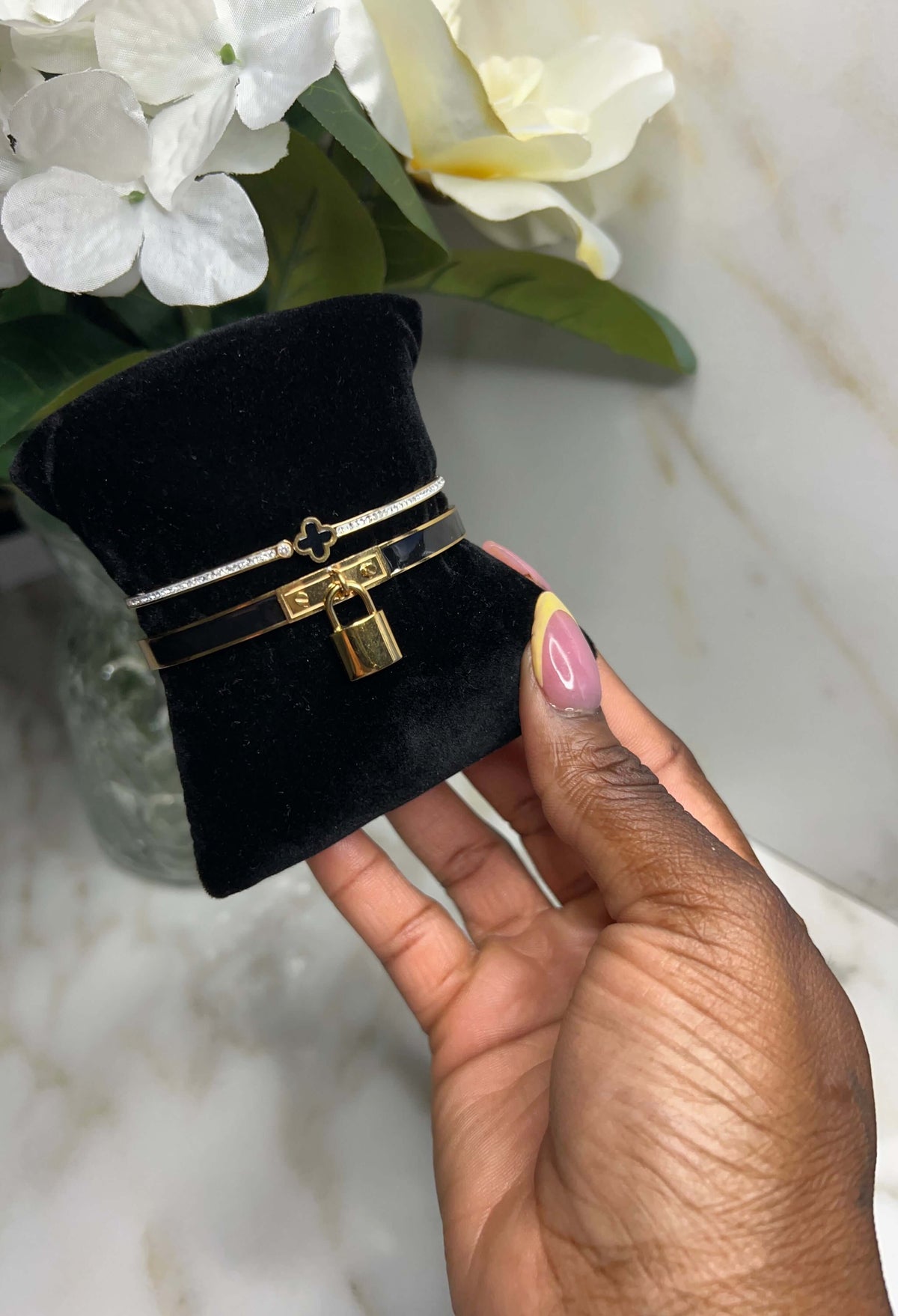 The Timeless Heart Reign Stack displayed on a black velvet stand, showcasing its elegant design and heart charm.