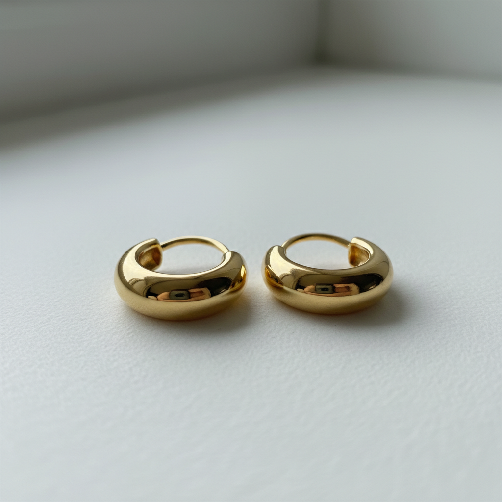 Sleek gold-filled dome hoop earrings on a clean white surface